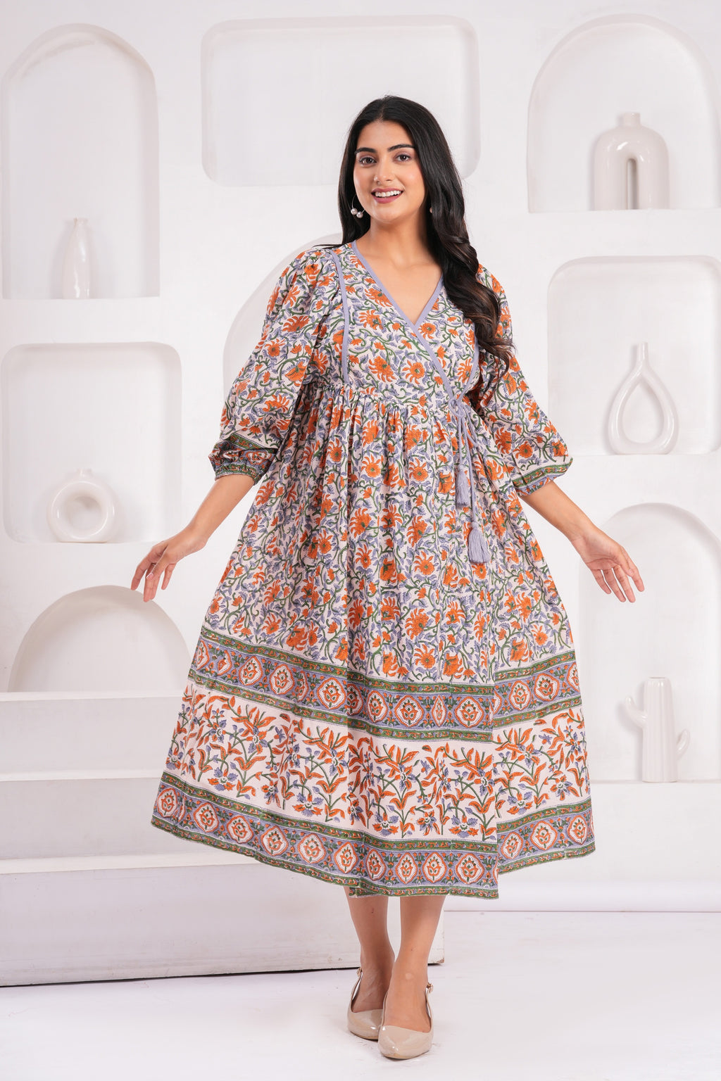 Woman wearing a floral dress against a white background