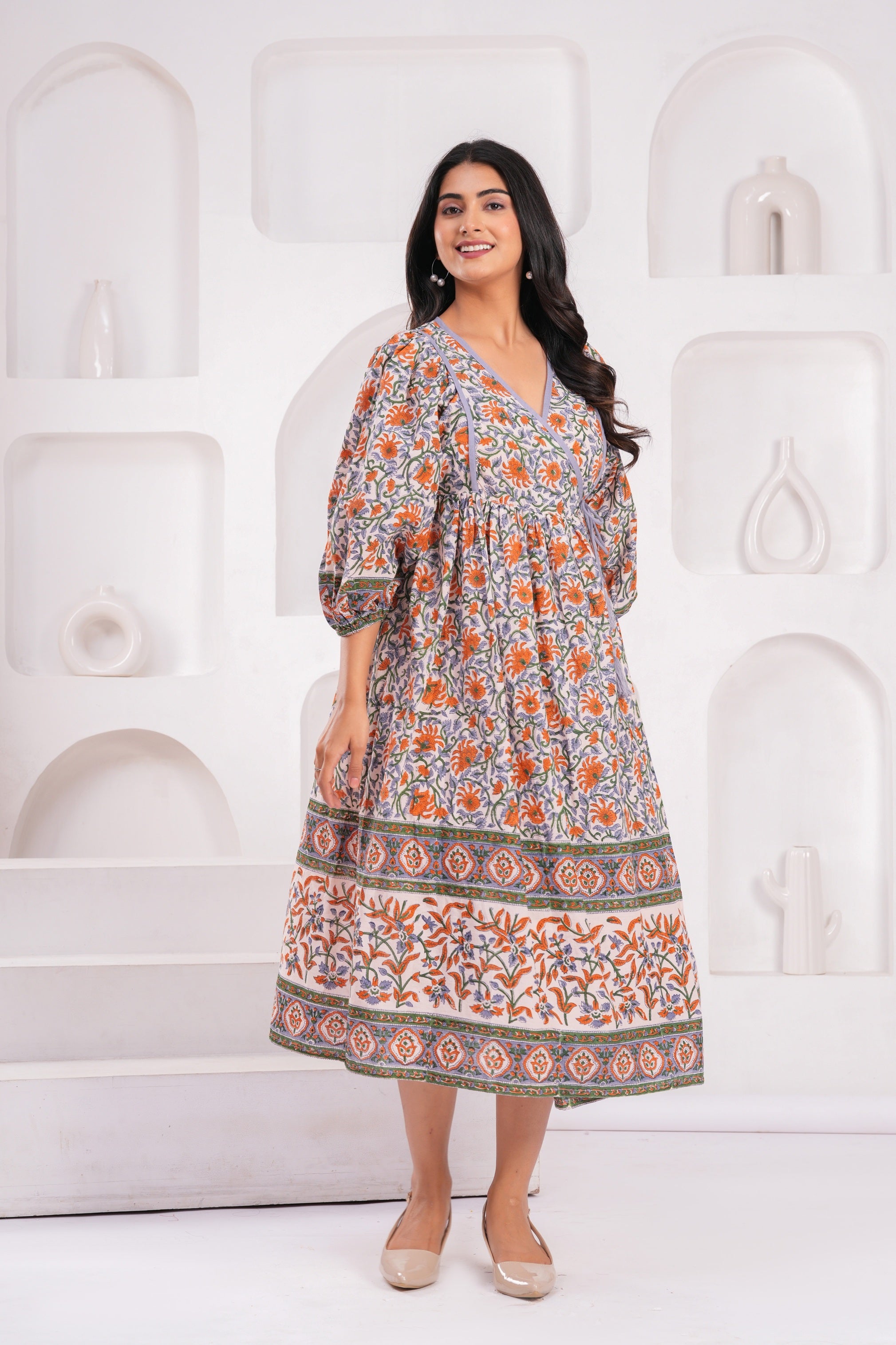 Woman wearing a floral dress against a white background